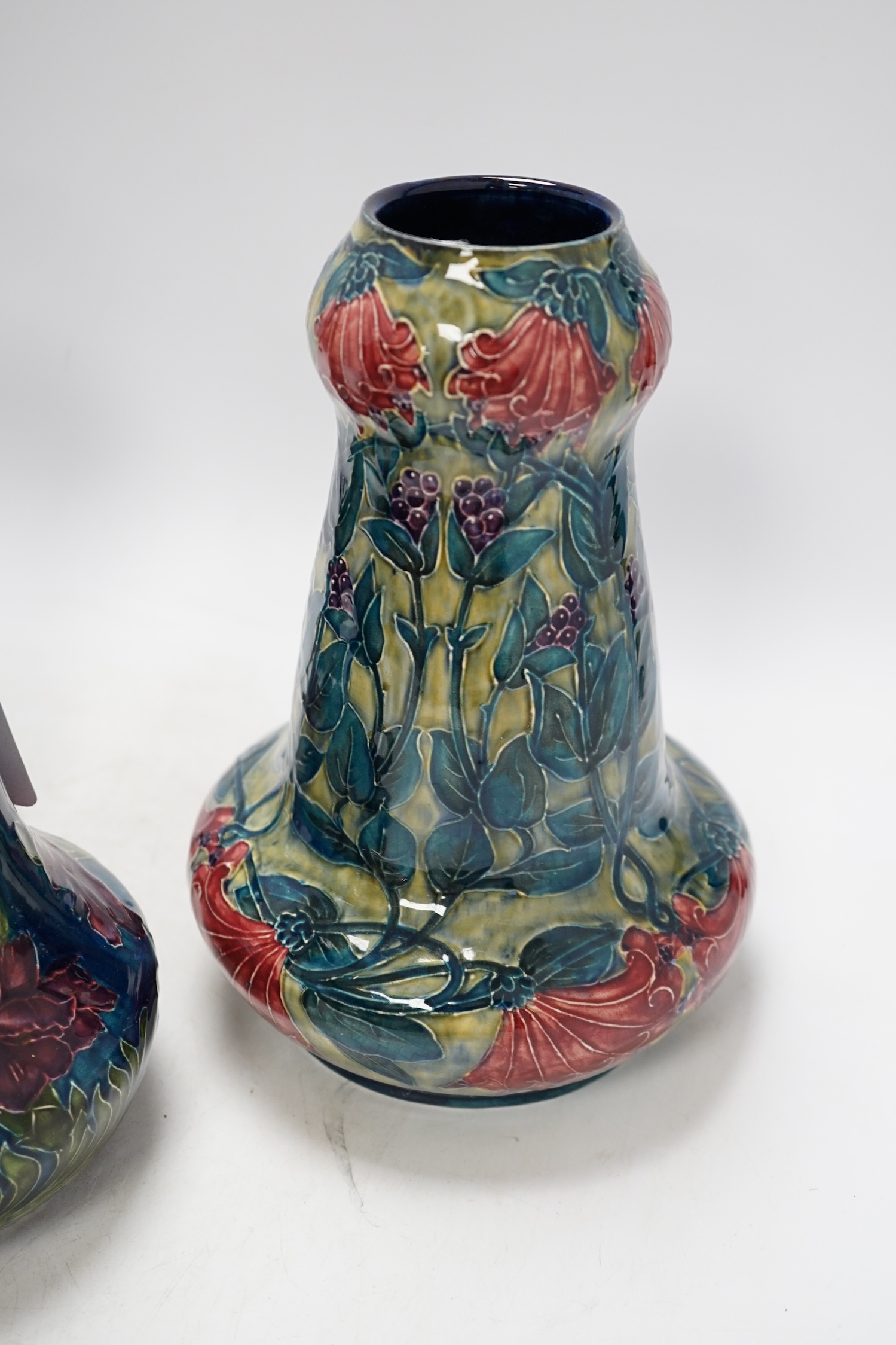 A pair of Hancock & Sons Morrisware vases, and another, designed by George Cartlidge, decorated with stylised flowers, 24cm high. Condition - fair to good, crazing throughout